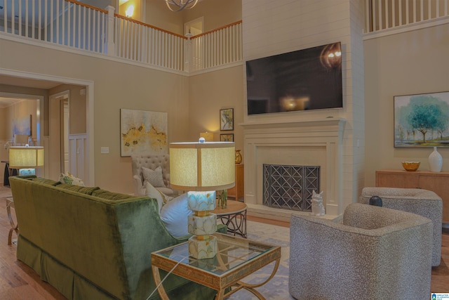 living room with hardwood / wood-style flooring and a high ceiling