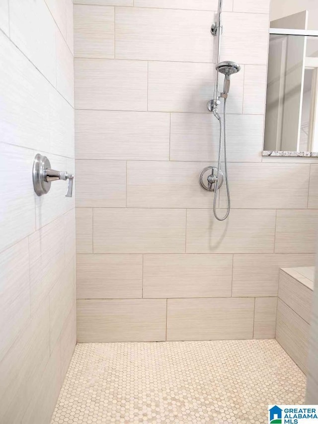 bathroom with a tile shower