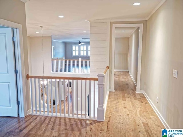 corridor featuring crown molding and light wood-type flooring