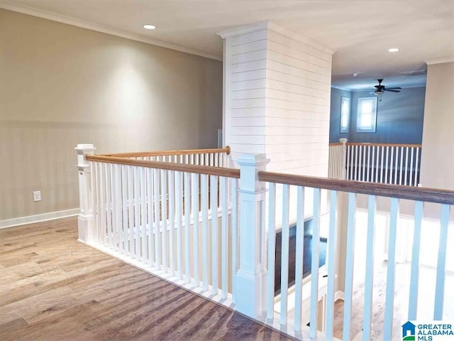 hall with ornamental molding and hardwood / wood-style floors