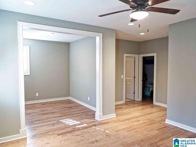 empty room featuring ceiling fan and light wood-type flooring