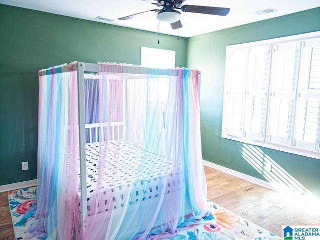 bedroom with wood-type flooring and ceiling fan