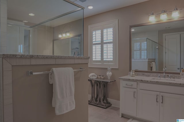 bathroom with tile patterned floors, vanity, and a shower with shower door