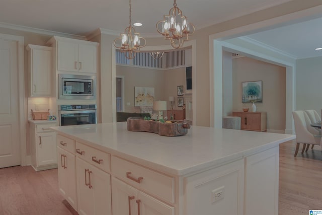 kitchen featuring stainless steel appliances, a center island, light hardwood / wood-style floors, ornamental molding, and white cabinets