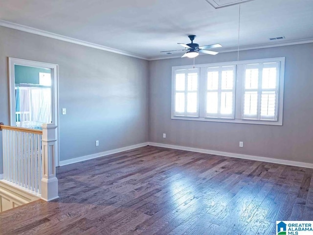 empty room with crown molding, plenty of natural light, and dark wood-type flooring