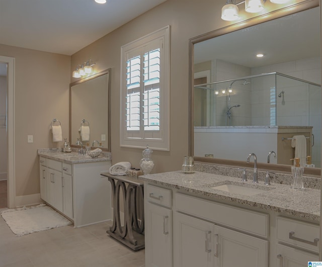 bathroom with a shower with door and vanity