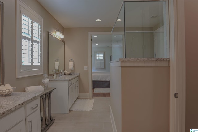 bathroom with vanity, tile patterned flooring, and a shower with door