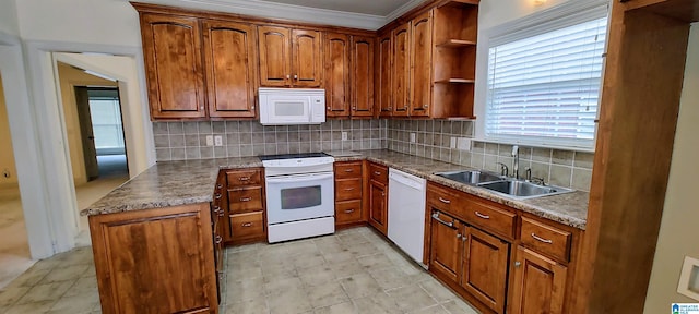 kitchen with light tile patterned flooring, tasteful backsplash, white appliances, and sink