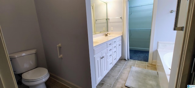 bathroom with double vanity, tile patterned flooring, a tub, and toilet