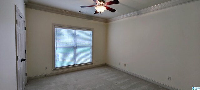 unfurnished room with crown molding, plenty of natural light, light colored carpet, and ceiling fan