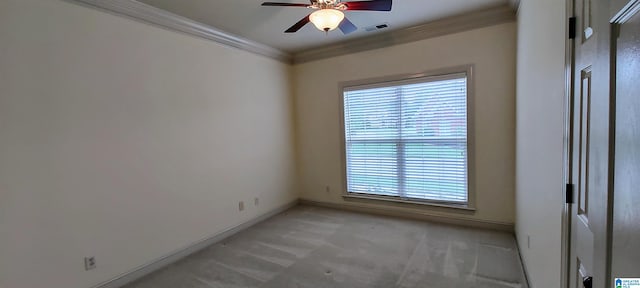 unfurnished room with light carpet, ceiling fan, and crown molding