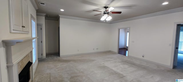 unfurnished living room with crown molding, light carpet, and ceiling fan