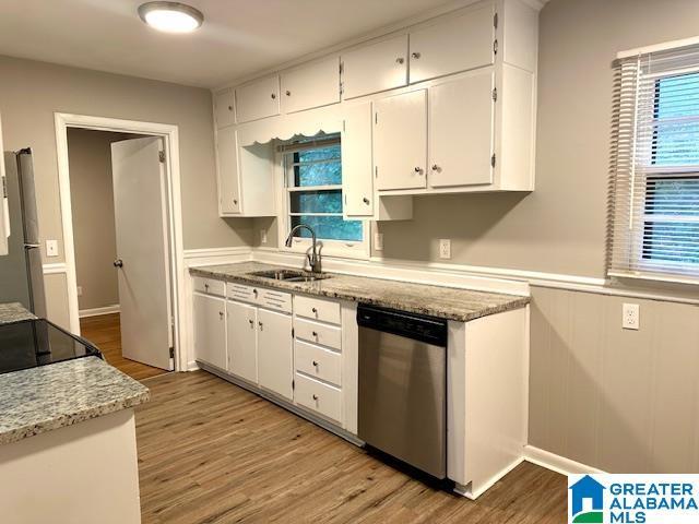 kitchen with sink, white cabinets, and appliances with stainless steel finishes