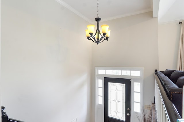 entryway with crown molding and a chandelier