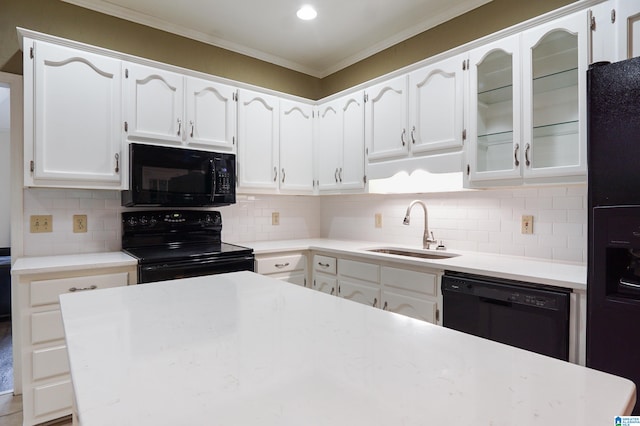 kitchen featuring white cabinets, sink, and black appliances