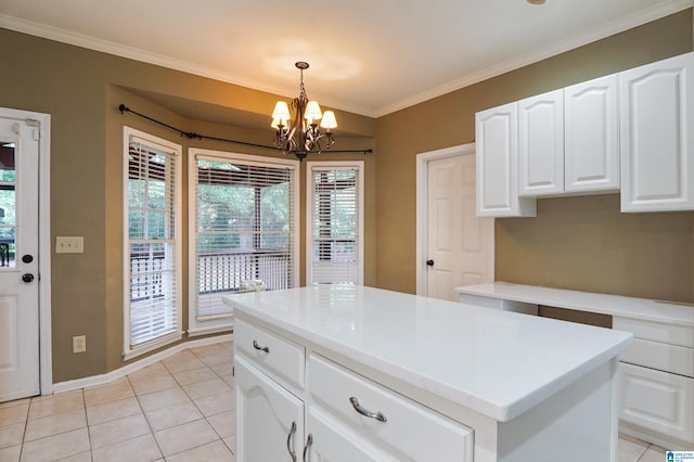 kitchen featuring white cabinetry, hanging light fixtures, a center island, ornamental molding, and light tile patterned flooring