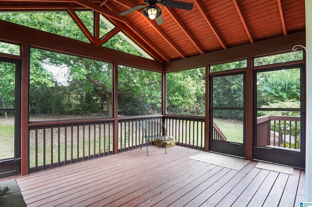 unfurnished sunroom featuring ceiling fan, wooden ceiling, and vaulted ceiling with beams