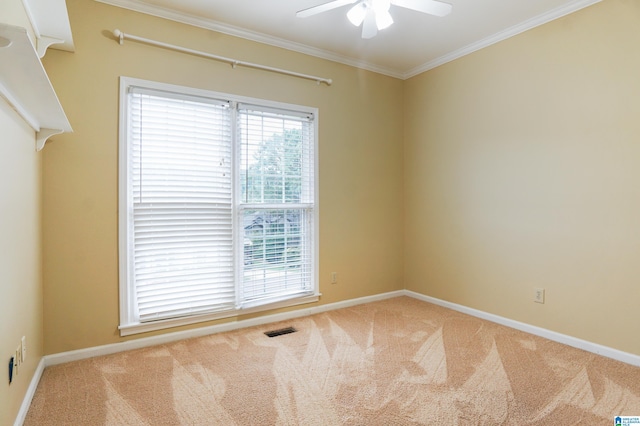 empty room with crown molding, carpet, and ceiling fan