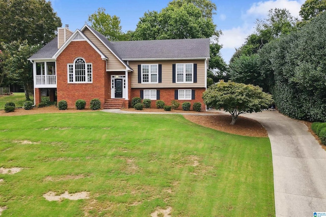 raised ranch featuring a front lawn