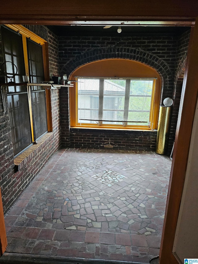 hallway with brick wall