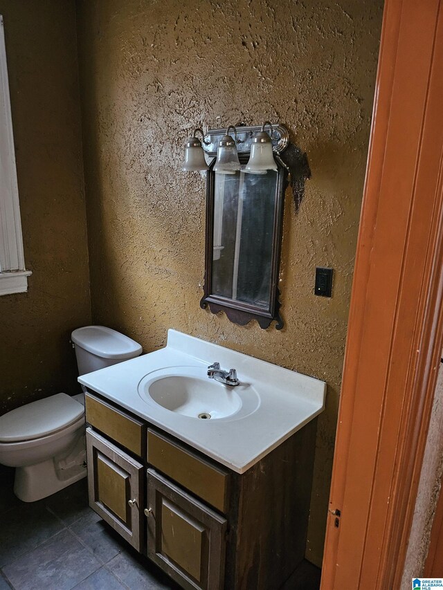 bathroom with tile patterned floors, toilet, and vanity