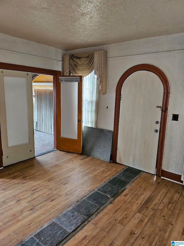 foyer with a textured ceiling and hardwood / wood-style flooring