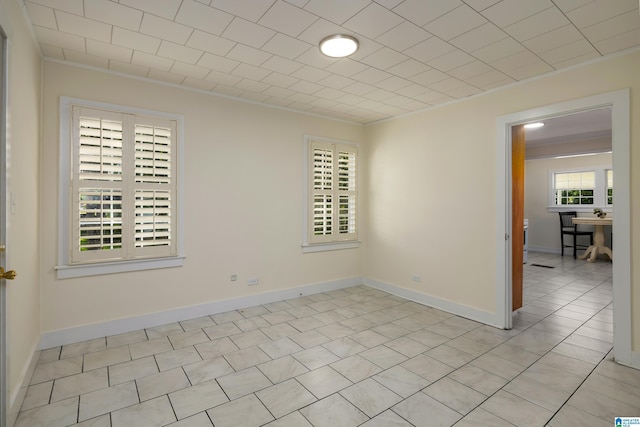 empty room featuring crown molding