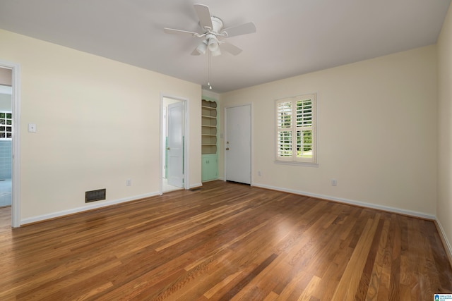 unfurnished bedroom with ceiling fan and wood-type flooring