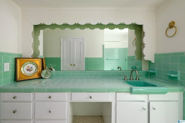 bathroom with ornamental molding and vanity