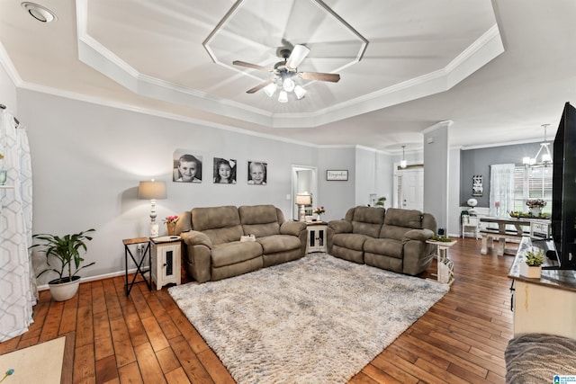 living room with crown molding and a tray ceiling