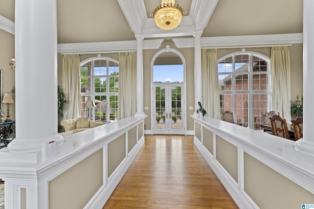 interior space with ornamental molding, light hardwood / wood-style flooring, and ornate columns