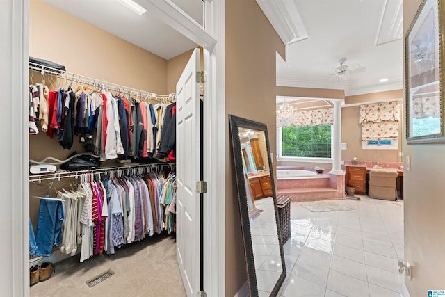 spacious closet with light colored carpet and ceiling fan