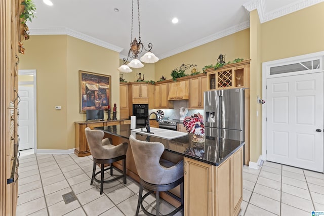 kitchen featuring stainless steel refrigerator with ice dispenser, sink, crown molding, a kitchen breakfast bar, and a kitchen island with sink