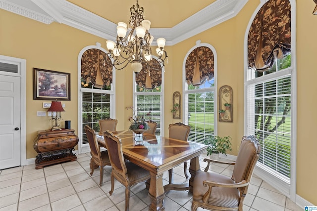 dining room featuring crown molding, light tile patterned flooring, and a notable chandelier