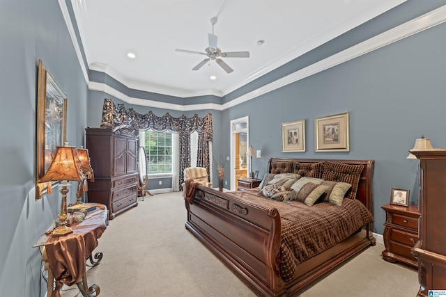 carpeted bedroom with ceiling fan, ornamental molding, and ensuite bath