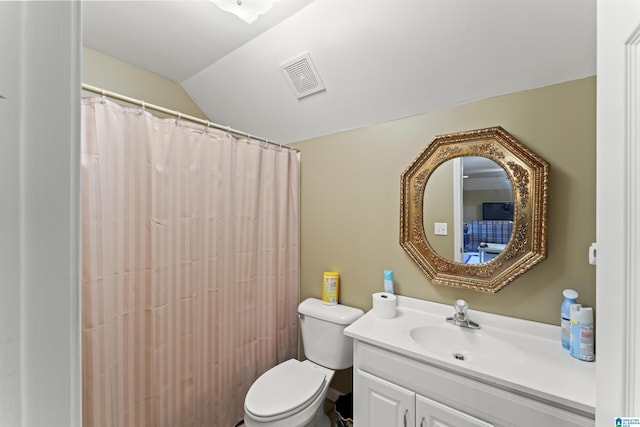 bathroom with vanity, lofted ceiling, a shower with shower curtain, and toilet