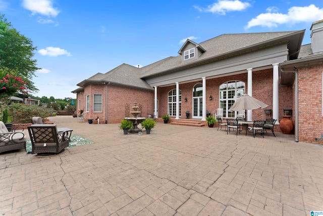 back of house featuring a patio and french doors