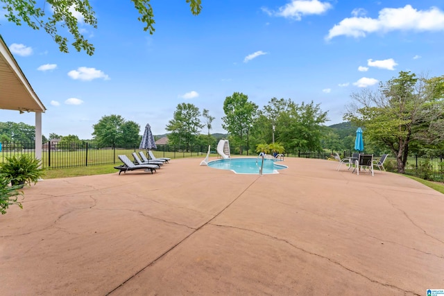 view of swimming pool featuring a patio area and a water slide