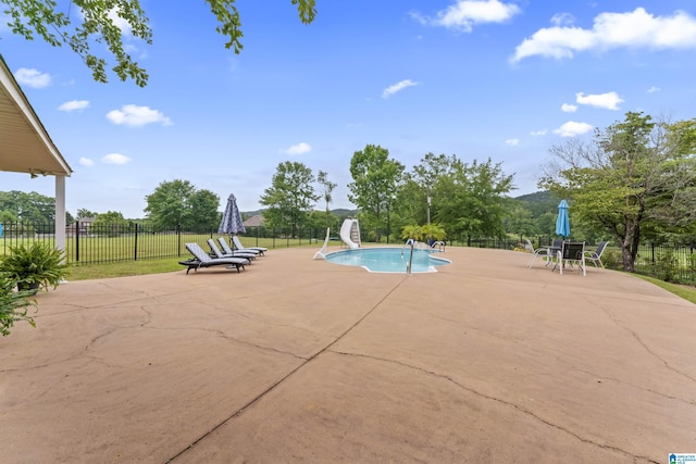view of swimming pool featuring a patio area and a water slide