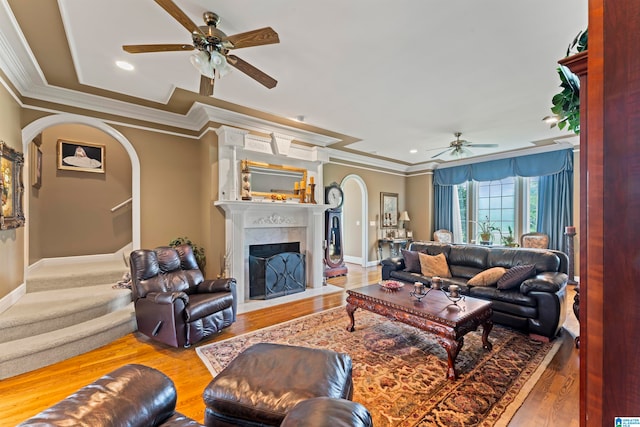 living room featuring ceiling fan, light hardwood / wood-style flooring, and ornamental molding