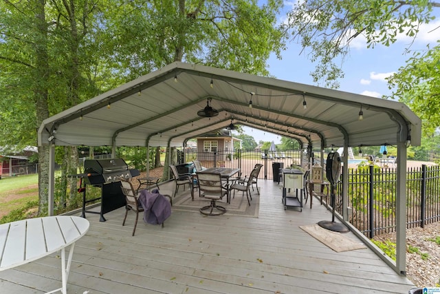 deck featuring a carport and a grill