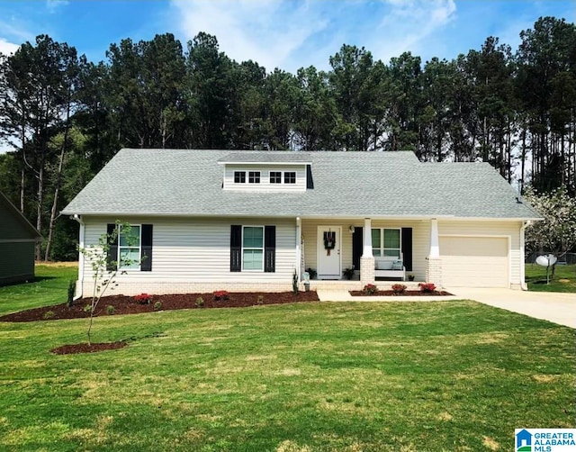 view of front of property with a garage and a front lawn