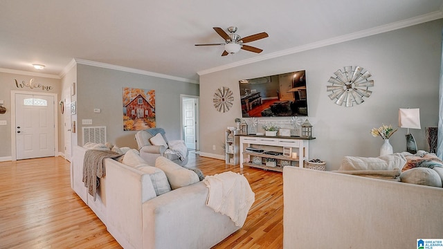 living room featuring crown molding, light wood-type flooring, and ceiling fan