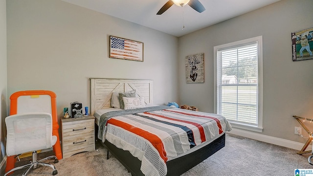 bedroom featuring light colored carpet and ceiling fan