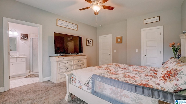 carpeted bedroom featuring ensuite bath and ceiling fan