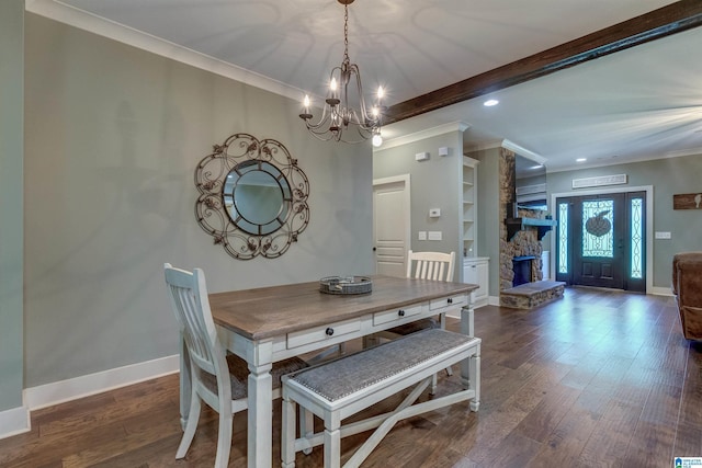 dining room featuring ornamental molding, built in features, and dark hardwood / wood-style floors