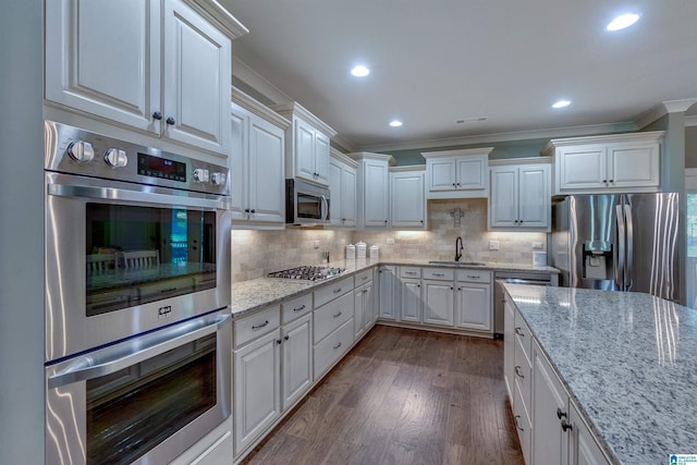 kitchen with dark hardwood / wood-style flooring, sink, backsplash, and appliances with stainless steel finishes