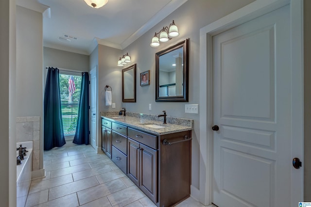 bathroom featuring crown molding, tile patterned floors, vanity, and a tub