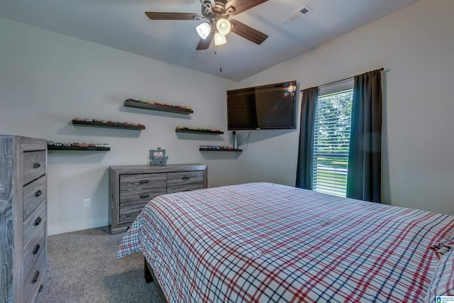 bedroom with ceiling fan, vaulted ceiling, and light carpet