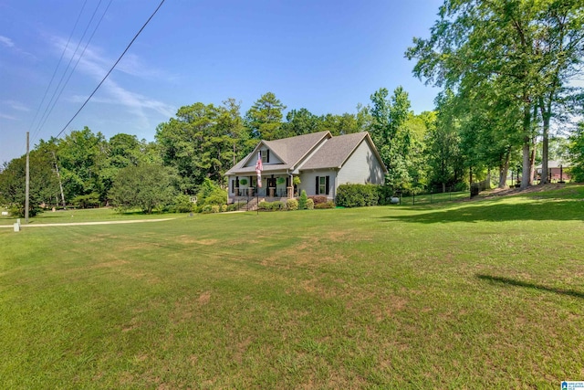 view of front of home featuring covered porch and a front lawn